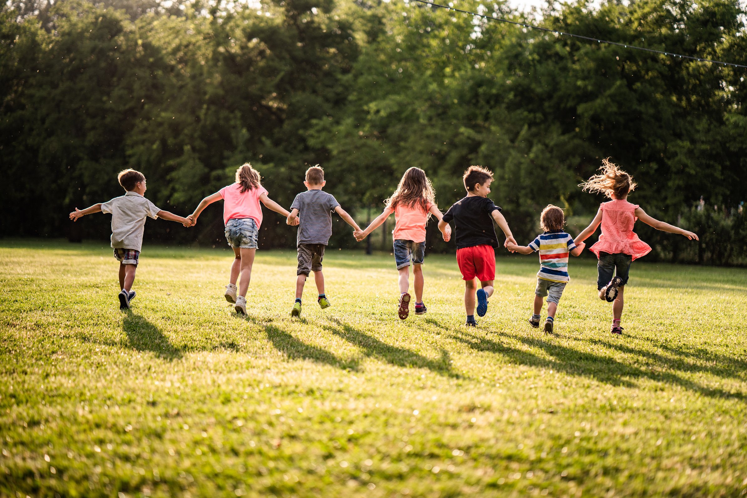 Back view group of children running in nature